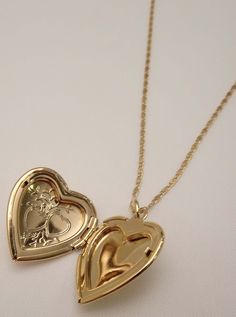 The Poppy Heart Locket Necklace is truly the ultimate timeless heart locket. It features a dainty necklace with heart locket with delicately etched hearts. Best of all, the heart locket is fully functional! You can open and secure your favorite cherished memory! Available in 24K gold or rhodium plating over steel Patent plating & sealant technology to ensure durability and long lasting wear Made in Los Angeles, CA | Nickel & Lead Free Dainty Open Heart Locket Necklace, Dainty Double Heart Locket Necklace, Dainty Open Heart Locket Necklace For Keepsake, Delicate Heart Pendant Locket Necklace, Dainty Heart Pendant Locket Necklace For Keepsake, Gold Plated Heart Locket Pendant Necklace, Dainty Double Heart Locket Necklace With Charm, Dainty Heart Locket Necklace For Keepsake, Dainty Yellow Gold Heart Pendant Locket Necklace