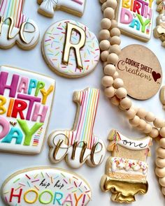 decorated cookies are arranged in the shape of letters, numbers, and other items on a table