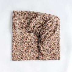 an unbuttoned floral print pocket square on a white background