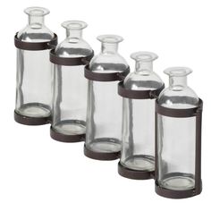 six glass bottles are lined up in a row