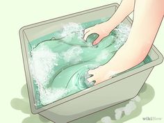 a person washing their feet in a tub