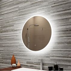 a bathroom with a round mirror on the wall