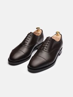 The Oxford is handcrafted to create a next level of sophistication and comfort. It's a confident, timeless and powerful shoe that does the speaking for you. Perfect for both formal and casual wear, these classics sharpen any modern man's shoe-arsenal.   Handmade in 128 steps. 61 dedicated working stations with artisans behind every stroke. Crafted using the Goodyear welt technique in Almansa, Spain. Classic Brogue Dress Shoes For Galas, Luxury Goodyear Welted Dress Shoes For Galas, Classic Wingtip Dress Shoes, Timeless Italian Cap Toe Leather Shoes, Classic Calf Leather Oxfords With Plain Toe, Timeless Leather Shoes With Goodyear Welt For Galas, Masculine Cap Toe Dress Shoes With Goodyear Welt, Classic Leather Shoes With Brogue Detailing, Elegant Goodyear Welted Oxford Shoes For Semi-formal Occasions