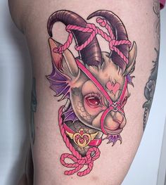 a goat with horns and rope around it's neck is shown on the thigh