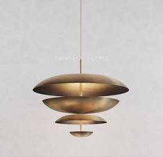 three circular lights hanging from a ceiling fixture