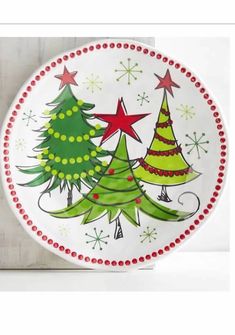 a plate with christmas trees painted on it