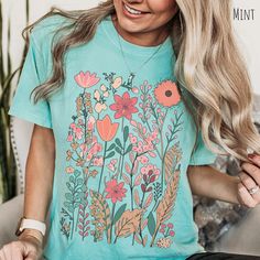 *Images are an accurate depiction of what you'll receive upon purchase. 🌷Introducing our new Comfort Colors Pastel Flowers Tee, part of our new Spring Collection.   This cottage core inspired nature shirt is perfect for any lover of the botanical world.  Spruce up your spring wardrobe, check out the rest of our spring collection to discover more!   This Comfort Colors medium-weight t-shirt is made from premium 100% cotton material, chosen specifically for its softness and durability, ensuring a Green Short Sleeve Tops With Plant Print, Green Tops With Plant Print Short Sleeves, Green T-shirt With Plant Print For Gardening, Green Floral Print Tops With Relaxed Fit, Green Graphic Tee With Plant Print, Green Graphic Tee With Plants Print, Green Floral Print Short Sleeve Top, Relaxed Fit Graphic Print Shirt For Gardening, Relaxed Fit Shirt With Graphic Print For Gardening