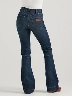 HAVE YOU MET BAILEY? Flattering from every angle, the Women’s Wrangler Retro® Bailey High Rise Trouser Jean is a best-kept secret for ladies who love volume. These denim trousers are crafted from a cotton blend with just a hint of stretch for all-day comfort. They come with a high-rise silhouette, a close fit through the thigh, and a 20.5” flared leg full of vintage vibes. Plus, the five-pocket styling, “W” pocket stitching, and logo patch bring an unmatched level of Western authenticity. Women’s Wrangler Jeans, Women Wrangler Jeans, Wrangler Jeans Women's, Pocket Stitching, Southern Outfits, Long Sleeve Kids, Christmas Outfits, Boys Bottoms, Wrangler Jeans