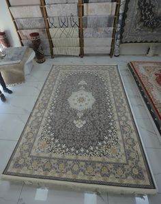 a large rug is on the floor in a room with many different colors and patterns