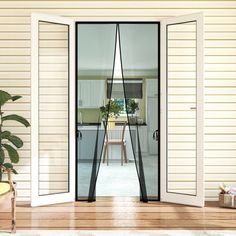 an open door leading to a dining room and living room with sliding glass doors on both sides