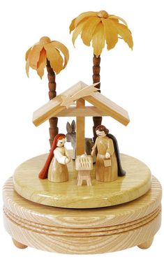 a wooden nativity scene with palm trees