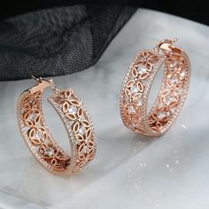 Introducing our exquisite 14K Rose Filigree Flower Hoop Earring, adorned with dazzling Crystals from Swarovski. This elegant piece seamlessly combines timeless design with modern glamour, making it a must-have accessory for any occasion. Crafted with precision, the filigree flower detailing adds a touch of delicacy to the hoop earring, creating a harmonious blend of sophistication and femininity. The radiant Crystals from Swarovski catch and reflect light, ensuring you sparkle with every step. T Crystal Hoop Earrings For Anniversary, Flower Shaped Hoop Earrings For Wedding, Elegant Flower-shaped Hoop Earrings Gift, Cubic Zirconia Plated Hoop Earrings, Rose Gold Small Hoop Earrings With Cubic Zirconia, Small Rose Gold Cubic Zirconia Hoop Earrings, Elegant Crystal Hoop Earrings, Party Rose Gold Hoop Earrings, Rose Gold Pierced Jewelry With Cubic Zirconia