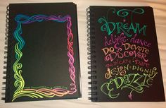 two notebooks with writing on them sitting next to each other