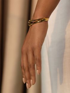 Handcrafted in 22k gold plated bronze, the undulating form of the Naia Cuff is inspired by the dance of the sun and the sea. Reminiscent of the infinite landscapes of liquid gold the sun paints upon the crests and troughs of the waves. Jewellery Simple, Pebble Ring, Gold Cuff Bracelet, Jewelry Wardrobe, Gold Waves, Bracelet Simple, Gold Jewelry Simple, Zodiac Pendant, Gold Bracelet Cuff