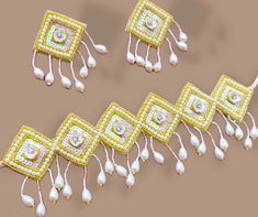 several pieces of jewelry are arranged in rows on a brown surface with pearls and other beads