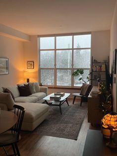 a living room filled with furniture and a large window covered in frosted glass windows