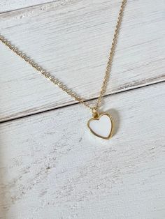 "Made with a dainty 18k gold filled mother of pearl heart charm and a 14k gold filled adjustable necklace chain. 🤍 Chain is adjustable from 16\"-18\" 🤍 Packaged beautifully in a kraft gift box" Everyday White Heart Necklace With Delicate Chain, White Heart-shaped Hypoallergenic Necklace, White Personalized Dainty Heart Necklace, Hypoallergenic White Heart Necklace, White Heart Charm Jewelry For Gift, White Heart Charm Necklaces As Gift, White Heart Charm Necklace As A Gift For Her, White Heart Charm Necklace For Gifts, White Charm Necklace With Heart Charm For Gift