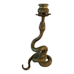 an old fashioned lamp with a snake on it's side and a candle holder in the middle