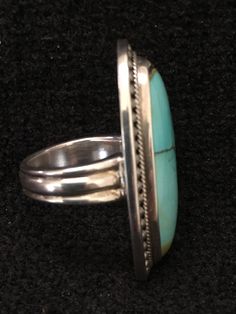 "Ring ~ Artist: Teresa Bradford-Cole Natural Stone Oval Turquoise Heavy Gauge Sterling Silver Be bold in style with this stunning long turquoise stone It features a long oval natural stone Many tribes considered turquoise to be a stone of the sky and wearing items of turquoise jewelry provided protection, good health, and long life. Size: 8 Length: 1 3/4\" Width:3/4 You deserve to know about my fabulous Treasure chest Modern Tribal Jewelry, Statement Piece Jewelry, Art to Wear Jewelry, Fantastic Classic Turquoise Ring For Formal Occasions, Oval Multi-stone Turquoise Ring, Oval Turquoise Multi-stone Ring, Turquoise Multi-stone Round Gemstones, Classic Formal Turquoise Ring, Turquoise Multi-stone Gemstones, Luxury Turquoise Cabochon Ring, Formal Handmade Turquoise Ring, Elegant Green Turquoise Ring