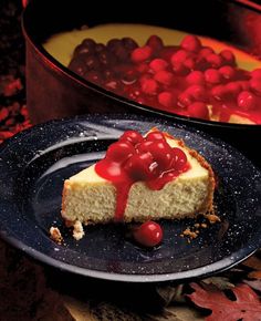 a cheesecake with cherries on top is sitting on a plate