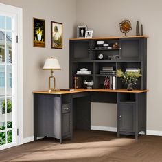 a corner desk with an open bookcase and lamp on the table in front of it