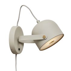 a white wall light with a cord attached to the arm and an outlet on the side