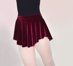 This soft and flowy ballet skirt is a beautiful and rich wine red. Our simple elegant style and flattering hemline looks great on everyone. -4 way stretch velvet -Rich maroon / dark red / wine / merlot / burgundy -Luxurious and soft with a pretty drape Dance teachers love this skirt because it is short enough to show correct technique. Youll love it for the graceful, flowing shape that shows off your dancers legs! All Royall Dancewear skirts are made of quality 4-way stretch fabrics. Weve... Fitted Balletcore Tiered Skirt, Balletcore Fitted Tiered Skirt, Fitted Tiered Skirt In Balletcore Style, Solid Stretch Skirt For Dance, Fitted Burgundy Pleated Skirt, Elegant Burgundy Lined Skirt Bottoms, Fitted Balletcore Party Skirt, Red Tiered Skirt For Dance, Elegant Skirted Dance Bottoms