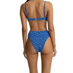 Fun, floral style meets eco-friendly comfort in the Rhythm Elodie Floral Smocked Hi Waist Bikini Bottom. This high-waisted bikini bottom is crafted with a smocked texture that adds a touch of elegance to our summer look, as well as a soft, stretchy recycled polyester blend to balance sustainability with all-day comfort. Casual High Waist Swimwear For Beach, Fitted Floral Print Bottoms For Vacation, High Waist Floral Print Swimwear For Sunbathing, Casual High Waist Swimwear For Pool, Fitted Printed Bottoms For Vacation, High Waist Swimwear For Spring Vacation, High Waist Swimwear For Vacation In Spring, Casual High Waist Swimwear For Beach Season, High Waist Floral Print Swimwear For Poolside