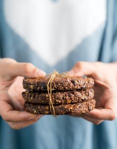 a person holding some kind of food in their hands and tied up with twine