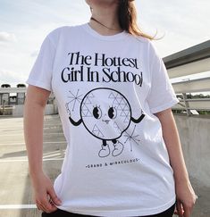 the hottest girl in school, EPCOT, epcot shirt, disney style, disney outfits, disney small shop, disney world outfit ideas, what to wear to disney, disney world shirt, spaceship earth, spaceship earth shirt, trendy disney outfits, disney outfit ideas, disney world outfit ideas, epcot disney, epcot outfit ideas Cotton Graphic School Tops, Graphic Cotton Tops For School, Cotton Graphic Tops For School, Cotton Graphic Design Tops For School, Cotton T-shirt For Streetwear With School Spirit, School Cotton T-shirt With Screen Print, Cotton Graphic Print T-shirt For Back To School, Cotton T-shirt For School Spirit Streetwear, Back To School Cotton Graphic T-shirt