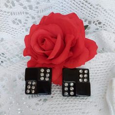 "Vintage Art Deco black lucite and rhinestone clip on earrings.  Art Deco, short for Arts Decoratifs, is characterized by rich colors, bold geometry and decadent detail work. Having reached the height of its popularity in 1920's, 30's and 40's, the style still brings in glamour, luxury and order with symmetrical designs. Both the 60's and 80's sae a revival of Art Deco.  These earrings are in excellent condition. There are not any scratches or discolouration. All rhinestones are intact.  They are square with 6 sparkling clear rhinestones in opposite corners. Each earring has a total of 12 rhinestones. The surface is shiny.  They measure 1.5 inches (3.8 cm) in width and length with clip on closures.  Our jewelry labelled \"vintage\" are in pre-owned condition with signs of age and wear as a Oversized Earrings, Earrings Art, Rhinestone Bow, Art Deco Earrings, Deco Jewelry, Vintage Pearls, Art Deco Jewelry, Clear Rhinestones, Vintage Art Deco