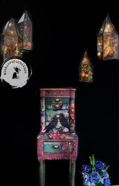 an old dresser is decorated with flowers and lanterns