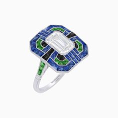 an art deco diamond ring with blue, green and white glass inlays on the band