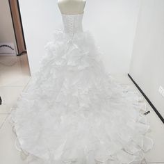 a white wedding dress on display in a room