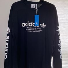 Long Sleeve Adidas Shirt. Never Worn, Ordered Wrong Size. Black Long Sleeve Shirt With Text Print, Branded Long Sleeve Tops For Streetwear, Long Sleeve Shirt With Text Print For Streetwear, Long Sleeve Text Print Shirt For Streetwear, Text Print Long Sleeve Shirt For Streetwear, Black Tops With Branding For Fall, Cotton Long Sleeve Shirt With Logo Print, Sporty Long Sleeve Streetwear Shirt, Sporty Long Sleeve Shirt For Spring