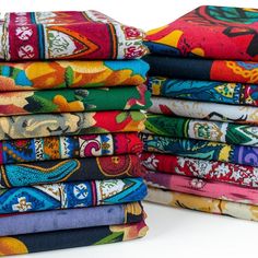 a stack of colorful cloths sitting next to each other on top of a white surface