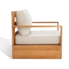 a white pillow sitting on top of a wooden bed frame with a seat and back cushion