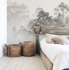 a white bed sitting in a bedroom next to a wooden headboard