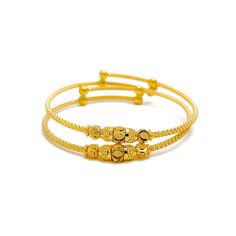 This pair of 22k gold baby bangles is both charming and ornate, offering a delicate design that exudes timeless beauty. Weighing a total of 9.4 grams, these bangles feature a radiant yellow gold finish with a 1.75-inch diameter. The adjustable design ensures a perfect fit as your child grows. The intricate detailing adds a touch of elegance, making this two-piece set an ideal gift that combines tradition with refined craftsmanship. Perfect for creating lasting memories, these bangles are a precious keepsake for any special occasion. PRODUCT DETAILS Gold Purity(karat): 22k Gold Weight(grams): 9.4 Item Finish: Yellow Gold Bangle Diameter: 1.75" Adjustable Bangle: Yes Number of Pieces: 2 Bangles Ceremonial 22k Yellow Gold Bracelet, Stackable Yellow Gold-plated Bangle, Adjustable Gold Plated Traditional Bangle, Adjustable Gold-plated Traditional Bangle, Adjustable Yellow Gold Bracelet With Intricate Design, Adjustable Traditional Gold-plated Bangle, Elegant Adjustable 22k Gold Bangle, Stackable Yellow Gold Plated Bracelet, 22k Yellow Gold Bracelet