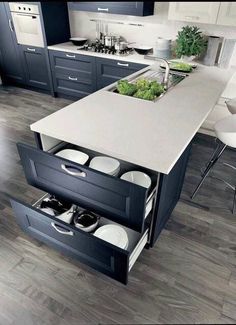 an open drawer in the middle of a kitchen