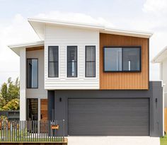 a two story house with white and brown siding