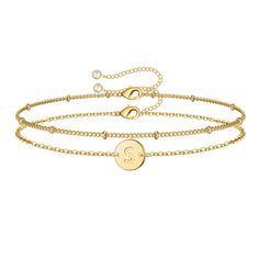 a gold bracelet with the letter g on it and a circle charm in the middle