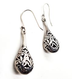 Filigree drop open work tribal Bali Balinese style sterling silver vintage drop earrings. Good vintage condition with little to no signs of normal vintage wear. Great patina present. Acid tests positive for sterling silver. Earrings measure 1 and 3/4ths of an inch tall and 1/2 of an inch wide. Traditional Sterling Silver Teardrop Earrings As Gift, Traditional Nickel-free Sterling Silver Teardrop Earrings, Traditional Handmade Sterling Silver Teardrop Earrings, Antique Silver Pierced Drop Earrings, Bohemian Sterling Silver Teardrop Plug Earrings, Traditional Silver Drop Earrings, Bohemian Teardrop Sterling Silver Plug Earrings, Traditional Silver Teardrop Pierced Earrings, Bohemian Pierced Teardrop Earrings In Sterling Silver