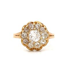 an antique diamond cluster ring in yellow gold