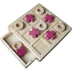 two wooden tic - tacs with pink crosses on them, one in the middle