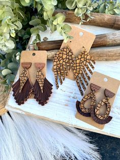 Earrings are made from a textured tan and deep brown cracked pattern genuine leather and pebbled solid brown genuine leather! Select the style from the drop down menu.  Retro fringe - Earrings are made from three layers of fringe and topped with a wooden half circle stud. Earrings measure approx 3" long.  Fringe Feather - A single layer of styled side fringe on one side. Earrings measure approx 3 1/2" long.  Teardrop - Earrings are made from two layers of leather and topped with a wooden half ci Artisan Brown Earrings For Pierced Ears, Handmade Brown Bohemian Plug Earrings, Handmade Bohemian Brown Plug Earrings, Artisan Brown Teardrop Earrings, Bohemian Brown Pierced Earrings, Rustic Brown Adjustable Earrings, Artisan Brown Pierced Earrings, Rustic Brown Drop Earrings, Handmade Brown Dangle Chandelier Earrings