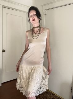 A simply stunning, 20's style, drop-waist 80's dress by Rina di Montella!  Cream crepe-back silk satin body with a delicate lace skirt overlay.  Floral pattern, eyelash scallop-edged lace is accented with pewter colored bugle beads and clear aurora borealis sequins.  Pulls on, with no closures.  Snap-close loops to hold slip/bra in place in strap interiors. This piece would be so lovely for a bride or maid of honor in a spring/summer wedding! *JEWELRY/OTHER ITEMS NOT INCLUDED* In very good condition.  There are a couple of barely noticeable teeny marks on top of shoulders where slip loop snaps were pressed against fabric, as well as a teeny pull in silk on lower/front body.   Marked a Size 10 (modern size small) Measurements: Bust: 34" Waist: 34" Hips: 38" Total length: 44" Elegant Fitted Sheer Slip Dress, Drop Waist Skirt Pattern, Sheer Fitted Silk Dress For Party, Sheer Fitted Silk Party Dress, Sheer Silk Party Dress, Chic Fitted Slip Dress With Delicate Lace, Fitted Slip Dress With Delicate Lace For Evening, Silk Evening Slip Dress With Delicate Lace, Evening Silk Slip Dress With Delicate Lace