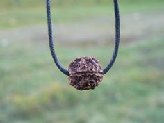 This Rudraksha pendant with 5 Mukhi real Rudraksh mala bead is hand-knotted using black or red cotton cord. It is beautiful piece of Hindu protection jewelry devoted to Lord Shiva, as Rudraksha is known as Shiva beads and meaning "Eye of Shiva" or "Tears of Shiva" in Sanskrit. The knots will slide down to a length that will fit a child and expand to fit men or women.  The Rudraksha that I use in this necklace is high quality bead, real and genuine, from India.  The rudraksha seeds itself are ver Rudraksha Necklace Women, Rudraksha Locket, Rudraksha Pendant, Single Rudraksha Chain, Silver Rudraksha Mala, Rudraksh Mala, Rudraksha Jewelry, Rudraksha Beads, Protection Jewelry