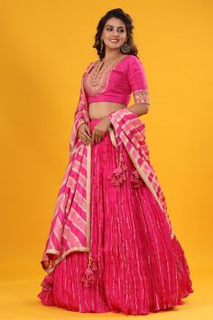 Pink gota patti embroidered set featuring silk dupatta set. It comes with a beautiful striped multicolor embroidered dupatta, pink blouse with hook closure and tie up at back. Pair it with beautiful jewelry to enhance your look. Shop online from Pure Elegance. Disclaimer: The actual product may vary slightly from the image. These are custom orders, hence expect slight variation in color, placement of the motif, or buta. ESTIMATED DELIVERYBecause this is a custom order, it would take about 4 week Banarasi Silk Sets With Gota Work For Reception, Art Silk Sharara With Gota Work For Navratri, Navratri Art Silk Sharara With Gota Work, Gota Work Sets For Reception And Navratri, Navratri Reception Sets With Gota Work, Reception Choli With Gota Work In Banarasi Silk, Banarasi Silk Choli With Gota Work For Reception, Traditional Drape Sets With Gota Work In Raw Silk, Reception Banarasi Silk Choli With Gota Work