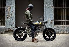 a man sitting on top of a dirt bike